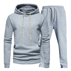 Detailed close-up view of a grey waffle-knit hoodie and joggers tracksuit set for men