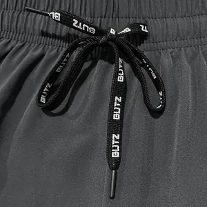 Close-up of black sports shorts drawstring with white "BUTZ" print detail
