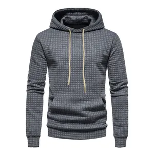 Detailed view of grey men's waffle texture jacquard hoodie with tan drawstrings