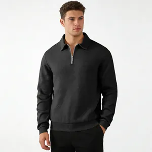 Close-up of men's black long-sleeve polo sweatshirt with unique geometric jacquard texture