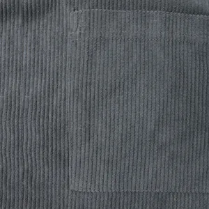 Close-up detail showing the ribbed texture and pocket of a grey-blue corduroy shirt.