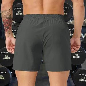 Macro view of grey men's athletic shorts back detail in a fitness gym environment