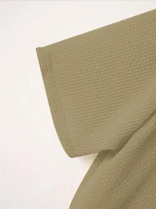 Macro detail of men's polo shirt featuring olive waffle-knit textured fabric