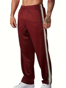 Detailed side view of men's burgundy gym sweatpants featuring stylish contrast side stripes