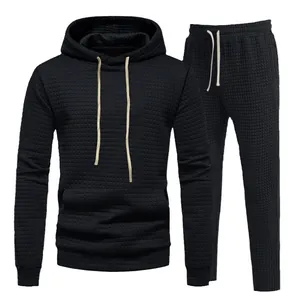 Men's black jacquard hoodie and sweatpants tracksuit set with waffle texture design.