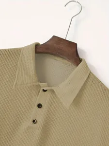 Close-up of khaki waffle-knit polo shirt showing textured collar and button detail