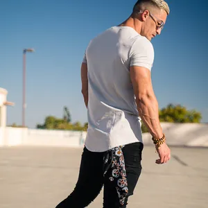 Back view of a muscular fit men's athletic t-shirt in light grey for gym training