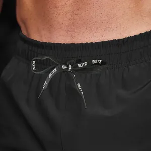 Close-up of black men's sports shorts featuring an adjustable drawstring waistband design
