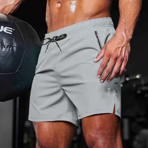 Close-up of men's grey athletic shorts with zipper pocket and elastic drawstring