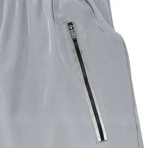 Detailed macro view showing the functional side zipper pocket on men's grey casual shorts