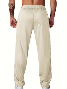 Detailed back view of men's beige sports joggers featuring side stripes and pockets.
