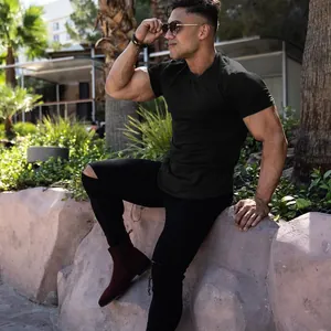 Professional close-up of a muscle fit black t-shirt on a male model for gym workouts.