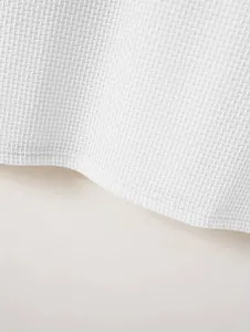 Detailed macro view of white pique fabric on a heavyweight men's polo shirt