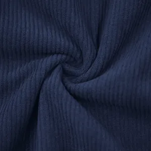 Detailed macro view of high-quality dark navy blue corduroy fabric showing soft ribbing texture