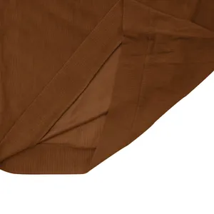 Close-up detail of a brown corduroy sweatshirt showing the side slit and fabric texture
