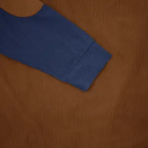 Macro view of ribbed cuff and corduroy fabric texture on a men's casual sweatshirt