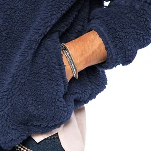 Close-up detail of navy blue sherpa fleece jacket sleeve and pocket texture for men