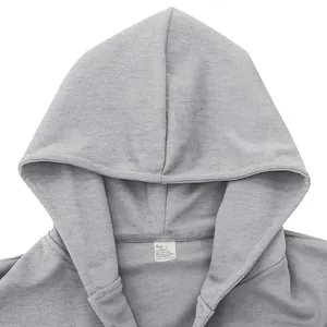 Detailed view of grey hooded jacket neck featuring a cotton blend fabric care label tag