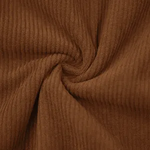 Close-up of high-quality brown corduroy fabric with vertical rib texture detail.