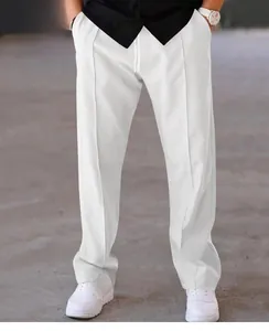Detail view of men's loose white straight-leg casual trousers with center crease