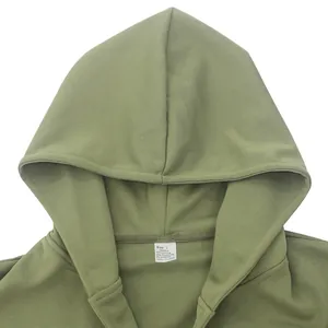 Close-up of size tag and fabric details inside a green men's hooded casual jacket