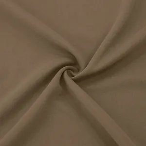 Macro view showing the smooth and high-quality brown fabric texture of the men's casual trench coat