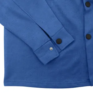 Close-up of blue suede workwear jacket showing black snap buttons and fabric texture