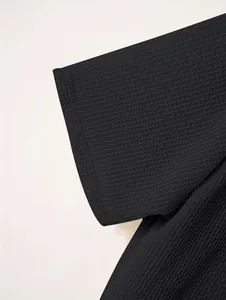 Close-up of black waffle textured short sleeve with high-quality stitching detail