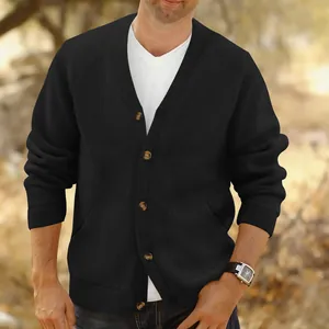 Detail view of men's black V-neck jacquard knit cardigan with button closure