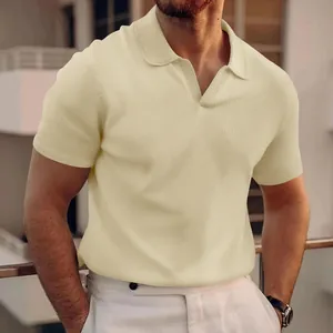 Close-up detail of a men's light yellow waffle texture polo shirt with stylish V-neck collar
