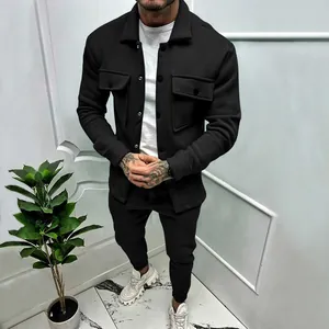 Detail view of men's black suede tracksuit with workwear jacket and casual pants.