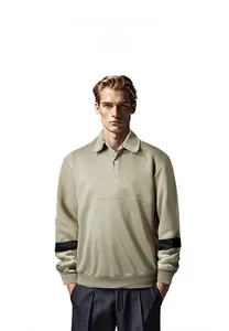 Male model wearing a khaki long-sleeve lapel sweatshirt with black arm stripes