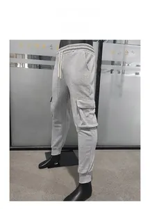 Detail of men's grey cargo joggers showing the side pockets and elasticated ankle cuffs