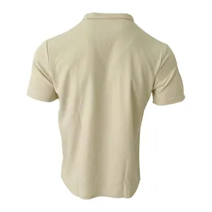 Detailed back view of a light beige waffle knit men's polo shirt showing fabric texture.