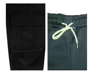 Close-up view of black cargo pants featuring drawstring waist and cargo side pocket