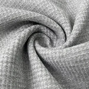 High-quality close-up detail of grey waffle knit fabric texture for men's polo shirt