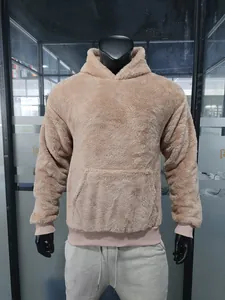 Close-up detail of a thick beige plush fleece pullover hooded sweatshirt on a mannequin