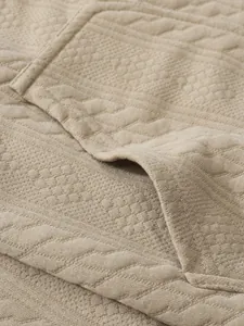 Macro detail view showing the textured jacquard knit fabric of men's casual cardigan
