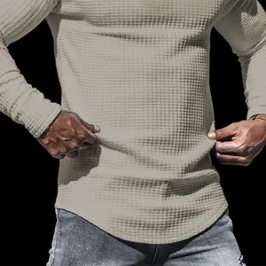 Nahaufnahme der Waffelstrick-Textur eines khakifarbenen Herren-Langarm-Sweatshirts