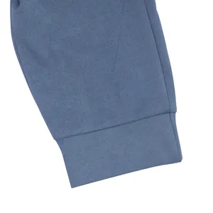 Close-up detail showing the soft faux suede fabric texture and durable cuff stitching of joggers