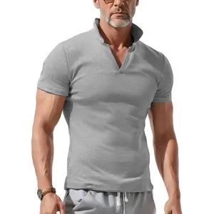 Detail view of men's grey waffle-knit polo shirt featuring a V-neck and short sleeves