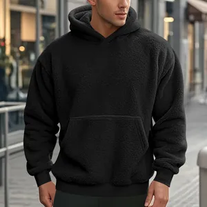 Detail shot of a men's black oversized sherpa fleece hoodie with kangaroo pocket