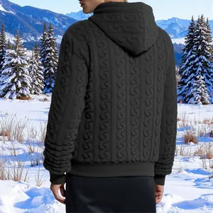 Detailed back view of a men's black cable-knit fleece hoodie set against a winter snow scene