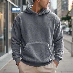 Close-up of grey fleece hooded sweatshirt showing plush texture and urban casual fit.