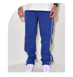 Detailed view of blue men's straight sports pants featuring side snap buttons and stripes