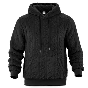 Detailed close-up view of a black cable-knit sherpa hoodie featuring textured jacquard pattern