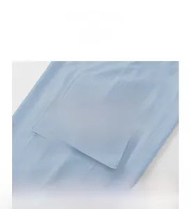 Close-up of light blue cargo pants fabric showing pocket detail and texture