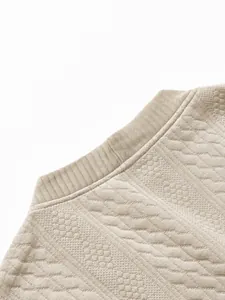 Detail view of a men's jacquard cardigan neck collar with textured knit pattern