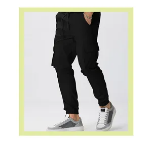 Detail view of men's black tapered cargo pants showing side pockets and drawstring waist.