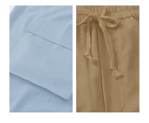 Detailed macro view of cargo pants showing drawstring waist and large functional side pockets
